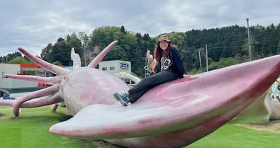 Ann on  playground equipment shaped like a giant squid.