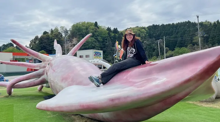 Ann on  playground equipment shaped like a giant squid.