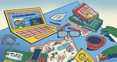 A laptop, map, and books about Japan.