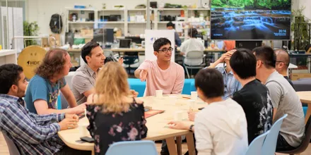 People sitting around a table in an animated discussion