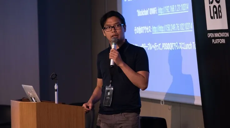 Anditto presenting at an event.