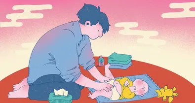 A father changing a newborn.